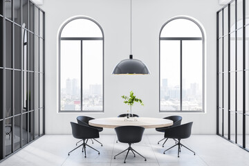 Stylish monochrome style room with light wooden round table and black chairs around on ceramic tales floor, city view from arched windows and modern black vintage lamp from top. 3D rendering.