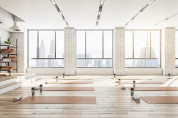  Contemporary concrete yoga gym interior with equipment, daylight and wooden flooring. Healthy lifestyle concept. 3D Rendering. © Who is Danny