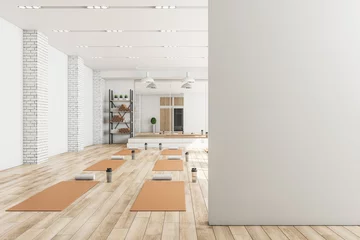 Schilderijen op glas Modern concrete yoga gym interior with equipment, blank mockup space on wall, daylight and wooden flooring. Healthy lifestyle concept. Mock up, 3D Rendering. © Who is Danny