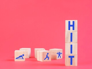 Text HIIT on wooden cubes with blurry background. Health and wellness concept.