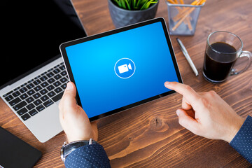 Man using online video conference app on tablet