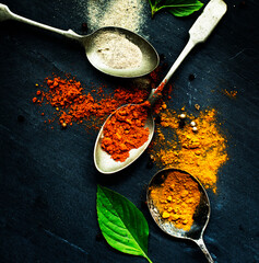 Teaspoons of herbs and turmeric powder