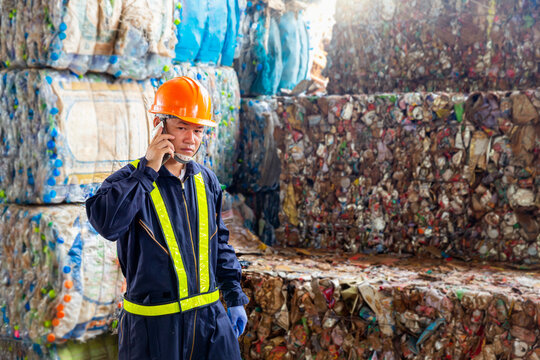 Engineer in paper and steel recycling plant. Employees at a plastic recycling plant are using mobile phones in the factory. .