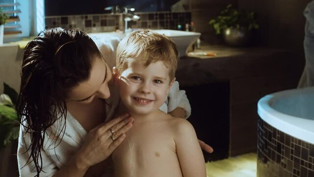 Happy mom and her son after bath