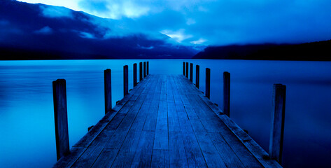 Tranquil lake with jetty, Nelson Lakes, New Zealand South Island.