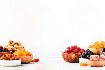 Healthy food snacks: natural dried fruits mix in bowls on white background