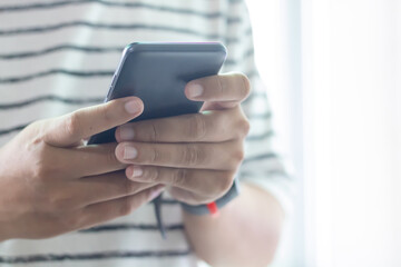 Hand holding and using smartphone .