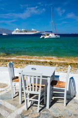 Catamaran yacht and cruise liner is Aegean sea. Chora, Mykonos island, Greece