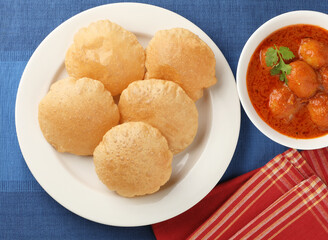 Indian food - Puri Bhaji. North India. Puri is a deep fried bread made from whole wheat flour & Served with Potato curry , bhaji or alu ki sabji.or Potato curry or dum alu curry
