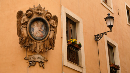 Fototapeta na wymiar Rome, Trevi neighborhood. Beautiful madonella -a catholic symbol of protection- in a corner.