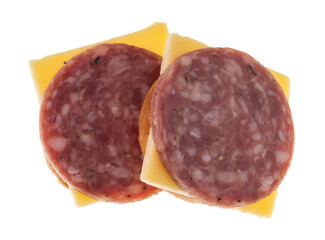 Side angle view of two snack crackers with dry salami and gouda cheese isolated on a white...