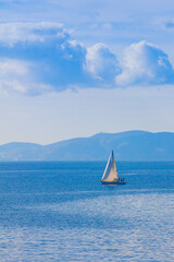 Sailing boat by Mykonos island in cyclades Greece