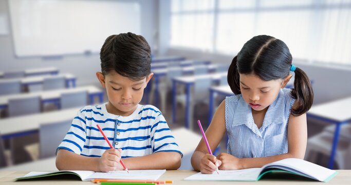 Composition of schoolboy and schoolgirl sitting beside each other working in class