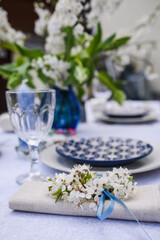 Obraz na płótnie Canvas Selective focus photo. Plum blooms as decor on lunch table.