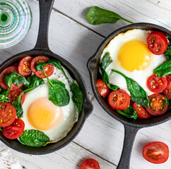 Freshly cooked egg and tomatoes in a pan
