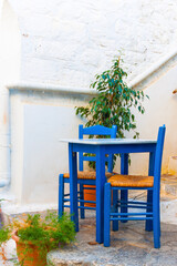 Traditional table with chairs at greek Island - 439315412
