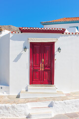Vivid red wooden door frame in Hydra Island Greece Saronikos Gulf - 439315662