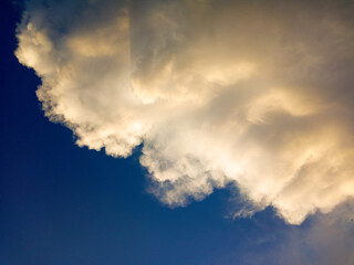 Naklejka na ściany i meble White clouds in the sky reflect the sun as a background.