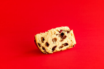 Chocolate panettone on red background. Christmas dessert.