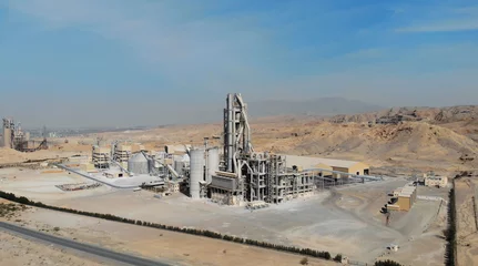 Foto op Canvas AERIAL. Top view of industry manufactory in UAE. Huge cement factory in desert. © skymediapro