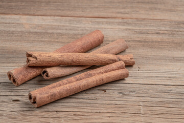 dried cinnamon sticks on wooden table with copy space