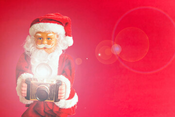 Santa Claus doll on red background. Santa Claus photographer.