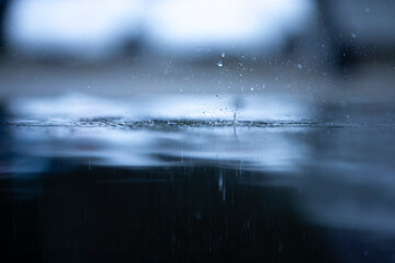 Fototapeta na wymiar rain drops on the water
