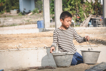 Portrait of a child in a construction site, stop child labor concept, Violence children and...