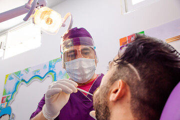 Dentist making dental examination to a patient in the dental office