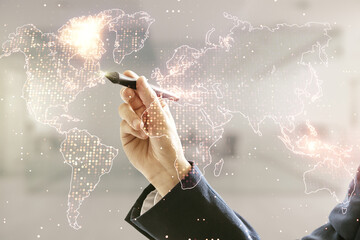Multi exposure of businessman hand with pen working with abstract graphic world map on blurred office background, big data and networking concept