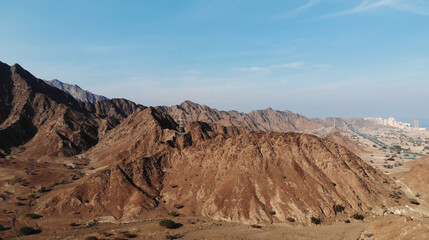 Fototapeta na wymiar AERIAL. Top view of Road between mountains in UAE