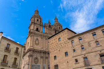 Fototapeta na wymiar View with Casa de las Conchas lateral facade and baroque iconic facade at the La Clerecía building, Pontifical university at Salamanca, Universidad Pontificia de Salamanca (UPSA)