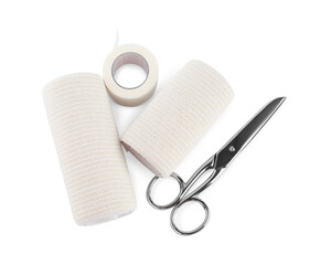 Medical bandage rolls, sticking plaster and scissors on white background, top view