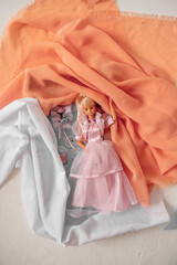 doll in the form of a girl with white hair and a pink dress