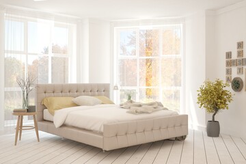 White stylish minimalist bedroom with armchair and autumn landscape in window. Scandinavian interior design. 3D illustration
