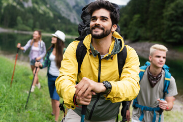 Group of happy hiker friends trekking as part of healthy lifestyle outdoors activity