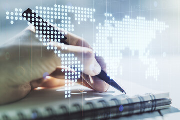 Abstract creative digital world map and woman hand writing in diary on background, globalization...