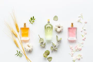 Fotobehang Floral fragrance - perfume bottles with flowers, top view © 9dreamstudio