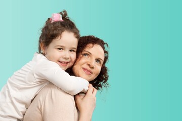 Happy woman have fun with child girl, stand behind hug kiss. Mother's Day love the family concept