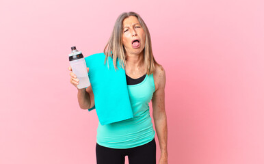 pretty middle age woman feeling disgusted and irritated and tongue out. fitness concept