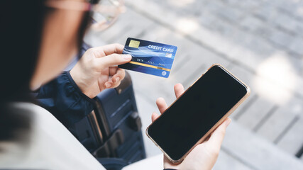 People hand holding mockup blank mobile phone screen and credit card.