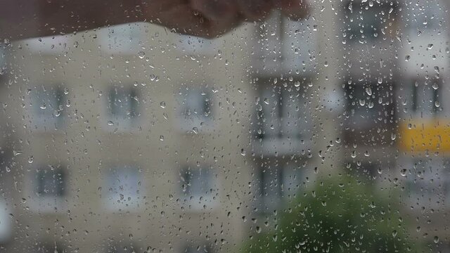The man wipes the window from the rain. washerman washes window glass.