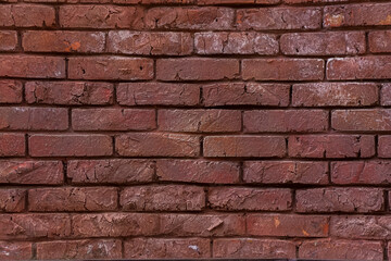 The texture of a red painted brick wall. Grunge background. Brick surface. Close-up background.