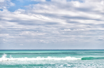 Happiness comes in waves. Sea water waves in Palm Beach Florida, USA. Sea under cloudy sky