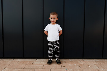 little boy in white t-shirt. space for your logo or design. Mockup for print