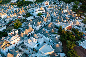 Fototapeta premium Aerial view of alberobello at sunset, the city of trulli in Puglia. a magical city and a beautiful landscape