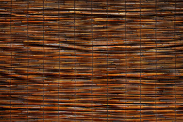 Woven bamboo or reeds hung for room partitioning or sunshade. Japanese style sunshade 'sudare' texture background