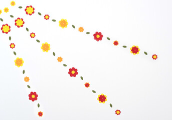 Bright red, yellow, orange paper flowers on white background. Spring, summer concept. Flat lay style with copy space