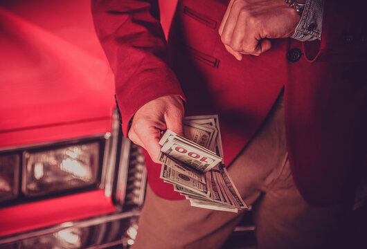 Car Salesman with Cash Dollars in His Hands
