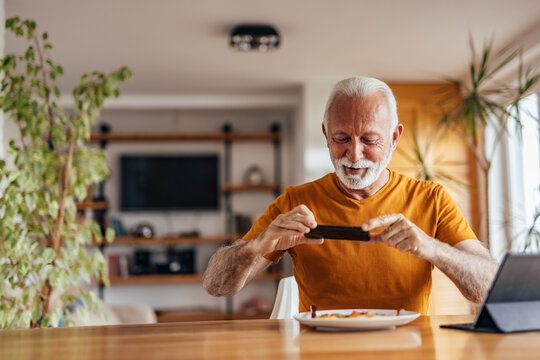 Senior man, posting a picture of his food online.